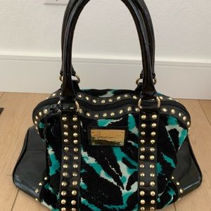 Used Betsey Johnson blue and black studded zip top tote.